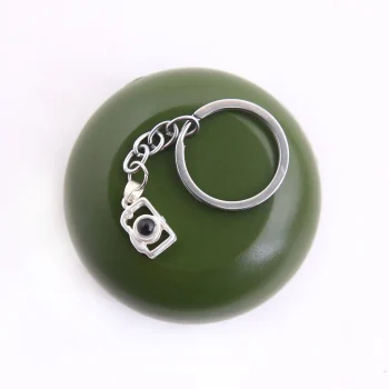 Platinum camera photo keychain featuring a hidden projection, perfect for keeping precious memories close.