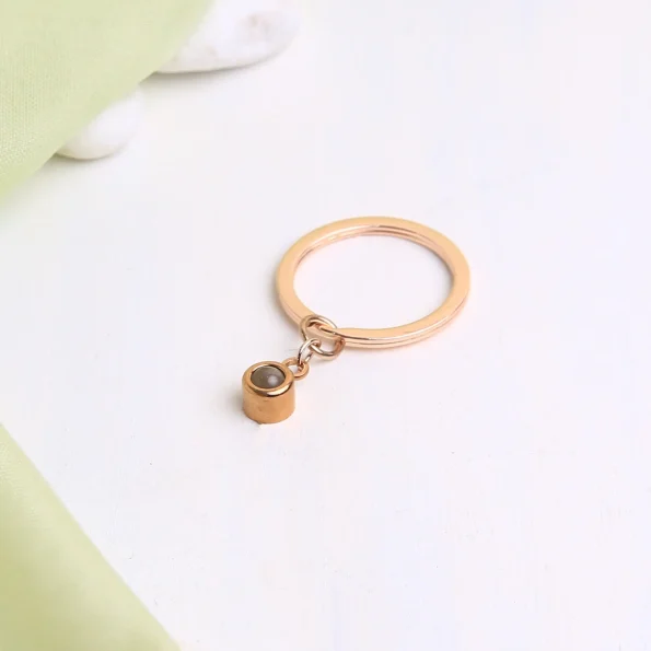 Rose gold circle photo keychain with a hidden projection, a timeless keepsake for your most precious memories.