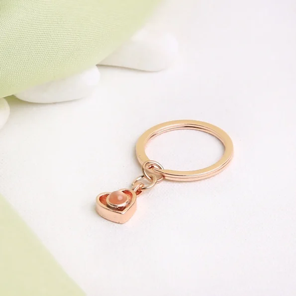 Rose gold heart photo keychain featuring a hidden image, perfect for sentimental gifting.