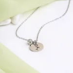 silver birthflower photo necklace close-up intricate detail