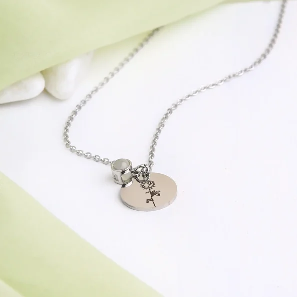 Elegant silver birthflower photo necklace featuring a hidden picture, a timeless and personal keepsake.
