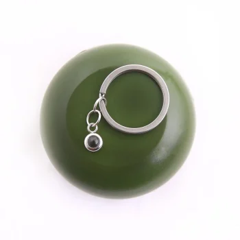 Elegant silver circle photo keychain with a hidden projection, perfect for carrying cherished memories close.