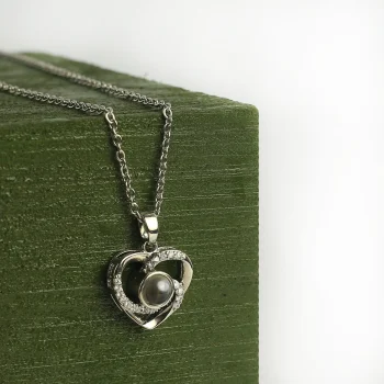Silver heart charm photo necklace with a hidden image, a timeless keepsake of love and memories.