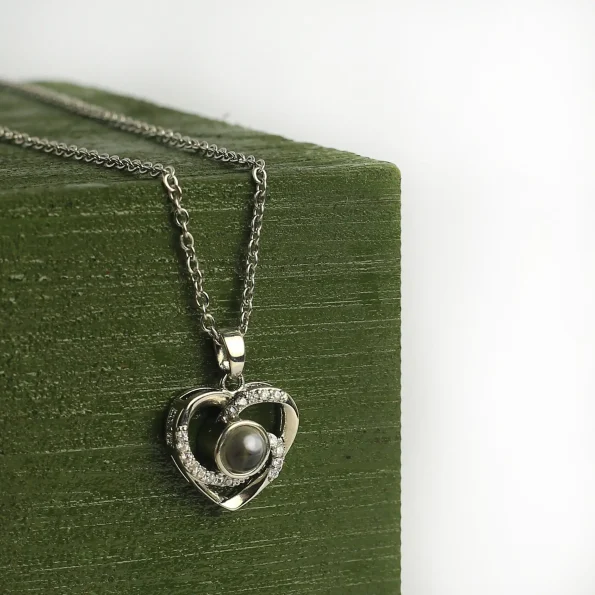 Silver heart charm photo necklace with a hidden image, a timeless keepsake of love and memories.