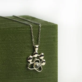 Elegant silver pet paw projection necklace with hidden photo, a timeless tribute to your furry friend.