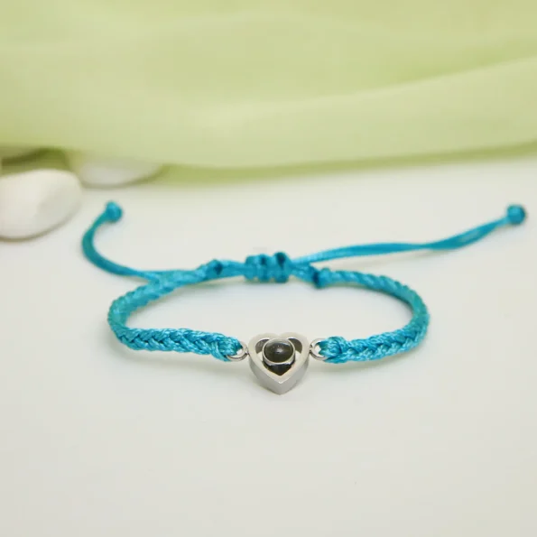 Turquoise rope heart bracelet with a hidden photo, blending elegance with personal meaning.