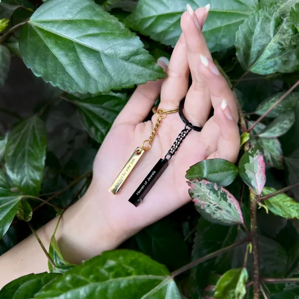 Woman holding a black pillar photo keychain engraved with Haven of Jewels, a sentimental keepsake to keep loved ones close.